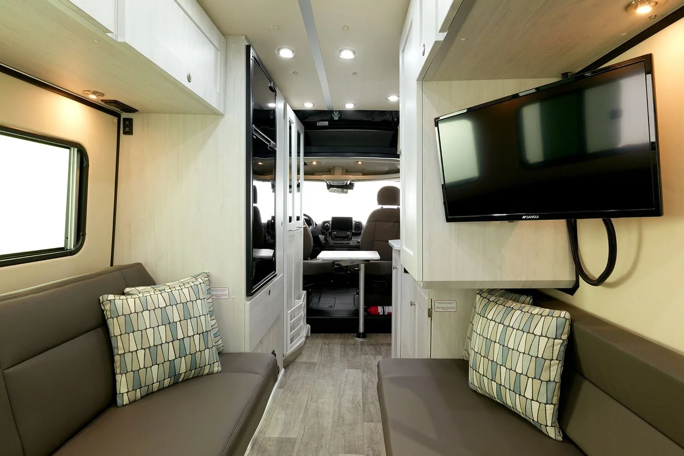 Roadtrek Zion Slumber camper van parked at an outdoor campsite with pop-top raised