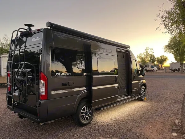 Winnebago Travato Class B camper van parked at a scenic outdoor campsite
